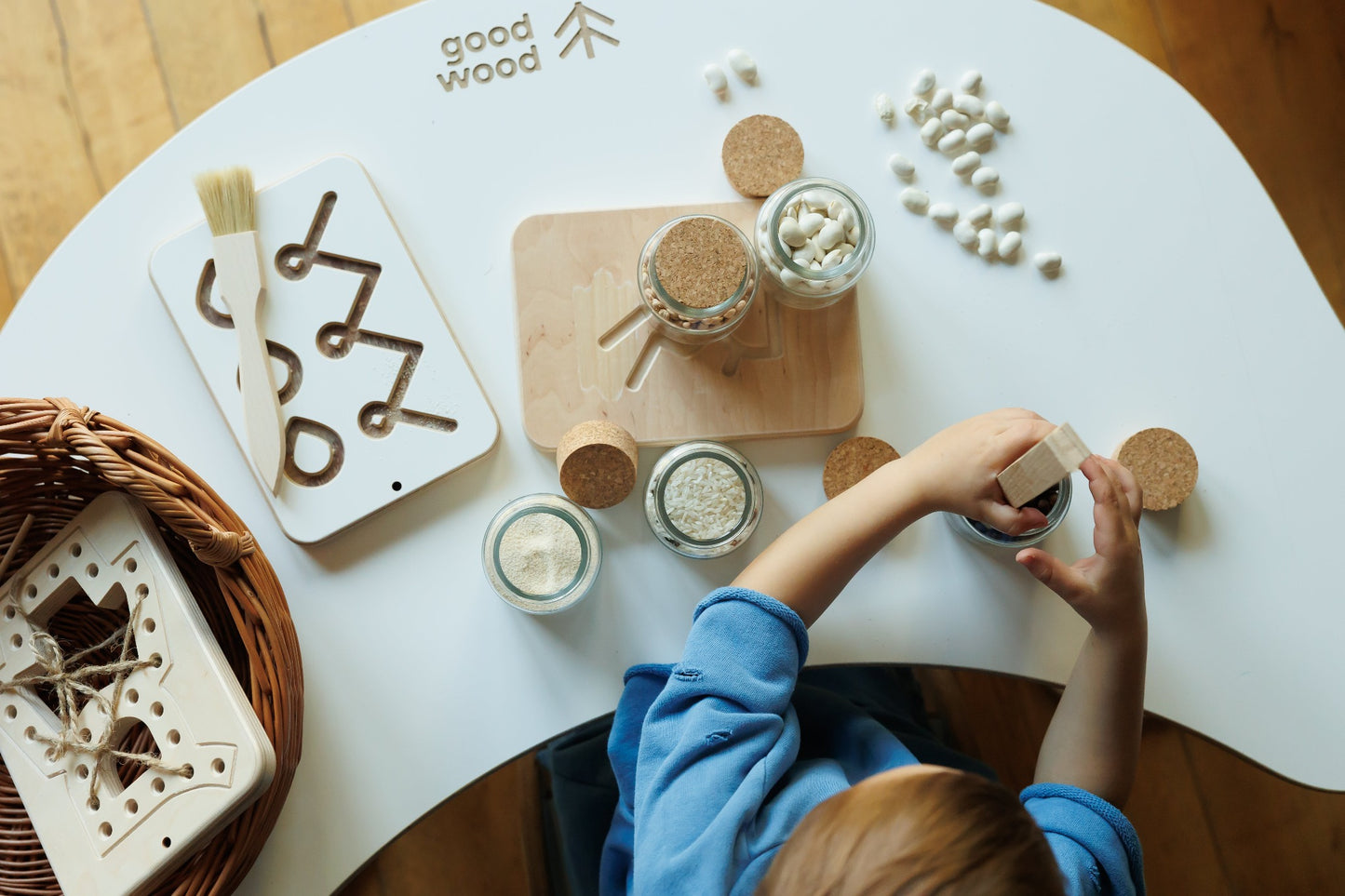 a boy playing good wood preschool wooden board