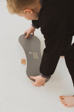 Load image into Gallery viewer, A BOY BALANCING ON THE GREY BALANCE BOARD / TRICK BOARD FOR KIDS- GOOD WOOD
